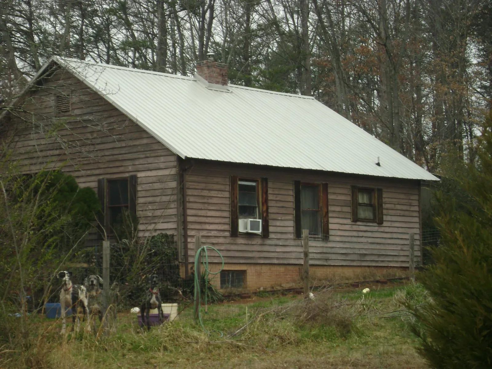White metal roof on an old wood sided farmhouse, from a Metal Roof Installation job in Argyle